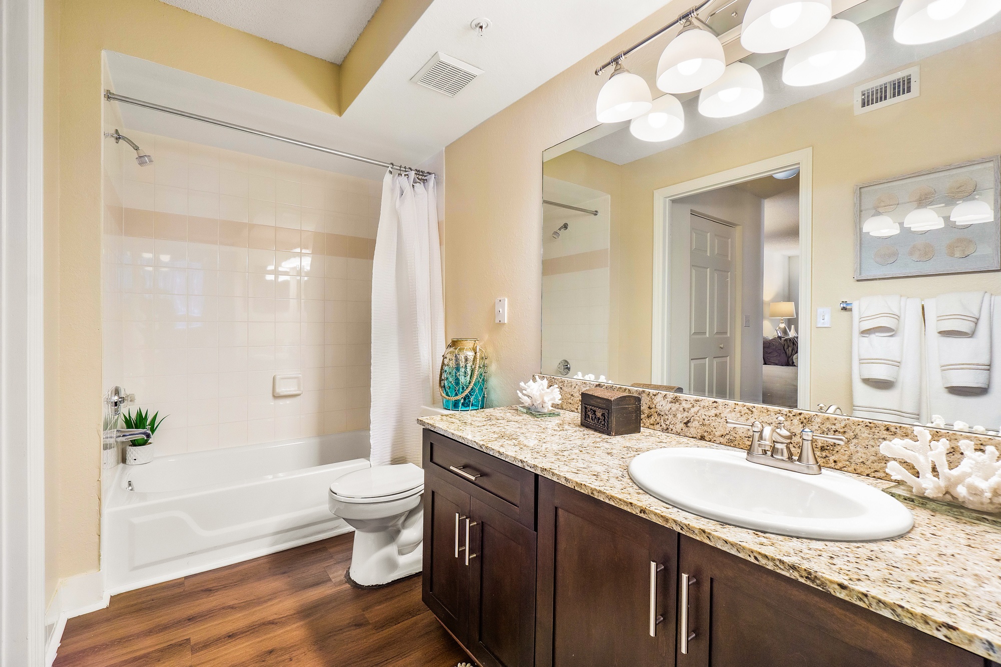 A bathroom with a white toilet and a white bathtub.